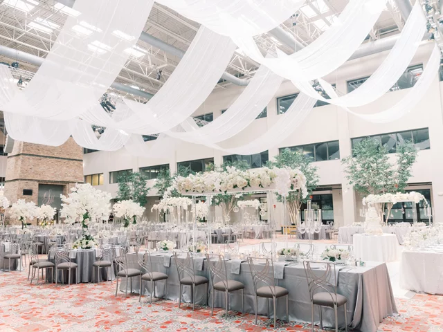 Wide shot of tables and chairs set up in The Atrium for a wedding