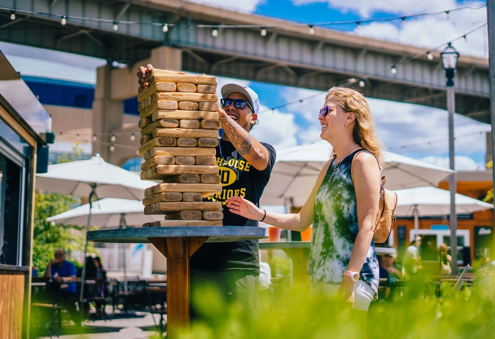 Couple playing Jenga at Canalside