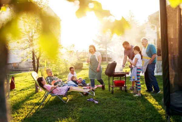 Family grilling and lounging in backyard