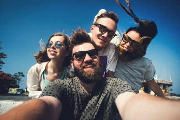 Four friends take a selfie while traveling