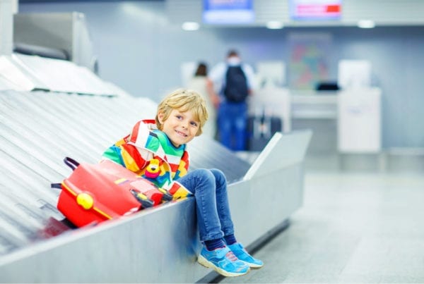 Kid with suitcase on a conveyor belt